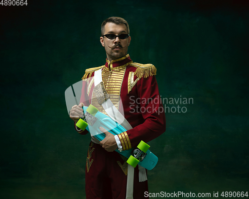 Image of Young man as Nicholas II on dark green background. Retro style, comparison of eras concept.