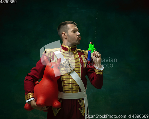 Image of Young man as Nicholas II on dark green background. Retro style, comparison of eras concept.