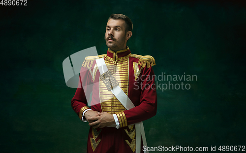 Image of Young man as Nicholas II on dark green background. Retro style, comparison of eras concept.