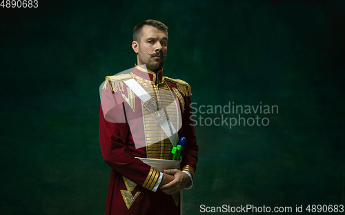 Image of Young man as Nicholas II on dark green background. Retro style, comparison of eras concept.