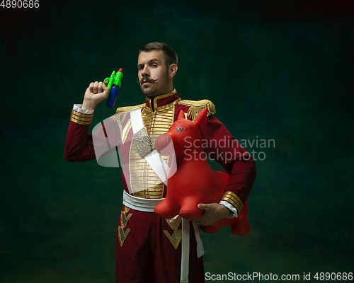 Image of Young man as Nicholas II on dark green background. Retro style, comparison of eras concept.