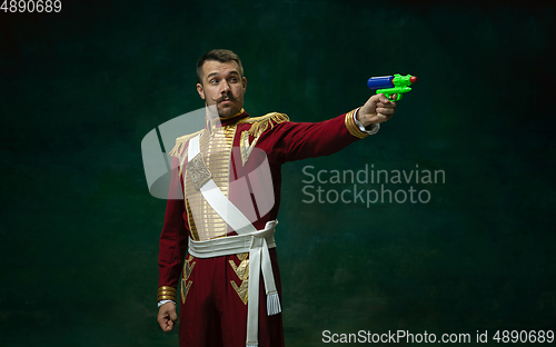 Image of Young man as Nicholas II on dark green background. Retro style, comparison of eras concept.