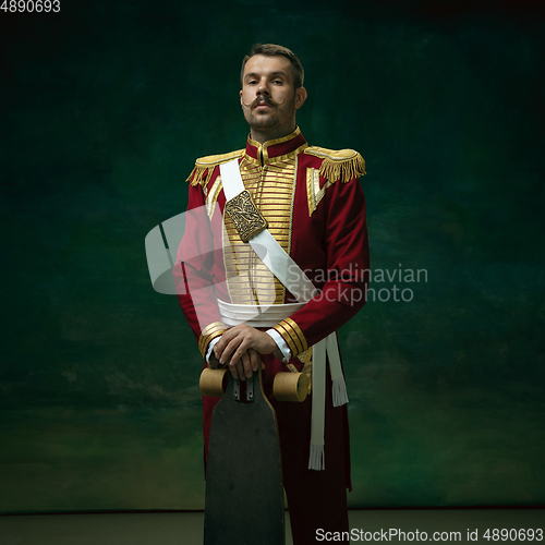 Image of Young man as Nicholas II on dark green background. Retro style, comparison of eras concept.