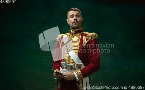 Image of Young man as Nicholas II on dark green background. Retro style, comparison of eras concept.