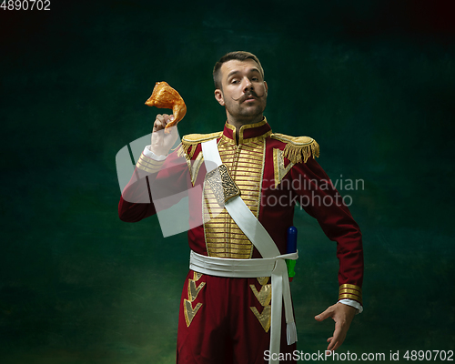 Image of Young man as Nicholas II on dark green background. Retro style, comparison of eras concept.