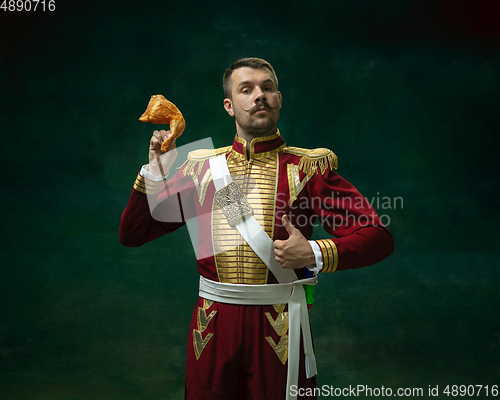 Image of Young man as Nicholas II on dark green background. Retro style, comparison of eras concept.