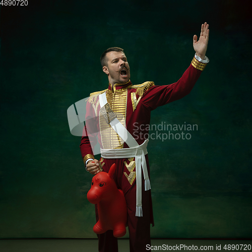 Image of Young man as Nicholas II on dark green background. Retro style, comparison of eras concept.