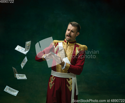 Image of Young man as Nicholas II on dark green background. Retro style, comparison of eras concept.