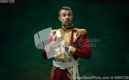 Image of Young man as Nicholas II on dark green background. Retro style, comparison of eras concept.