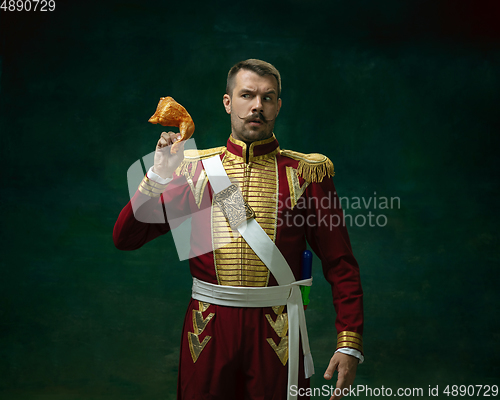 Image of Young man as Nicholas II on dark green background. Retro style, comparison of eras concept.