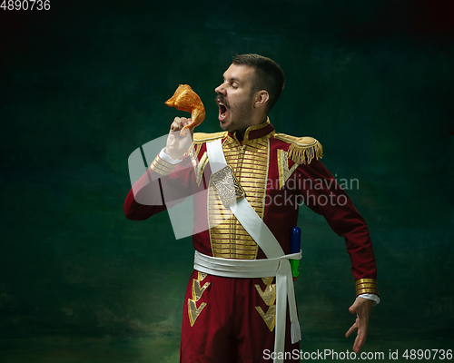 Image of Young man as Nicholas II on dark green background. Retro style, comparison of eras concept.