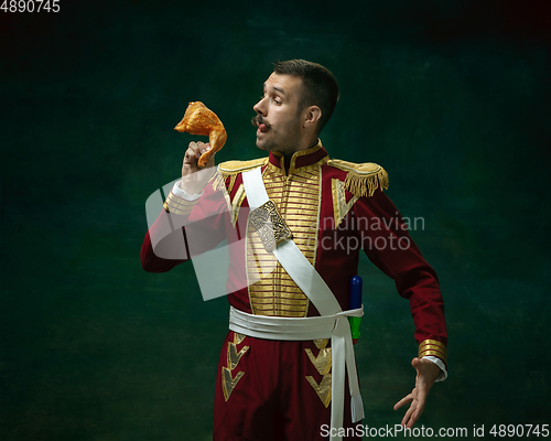 Image of Young man as Nicholas II on dark green background. Retro style, comparison of eras concept.