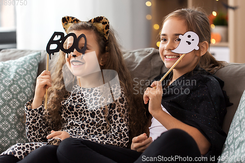 Image of girls in halloween costumes with party props