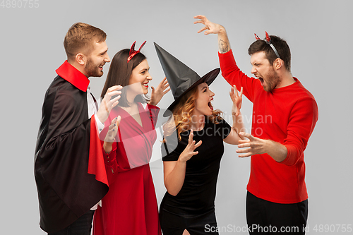 Image of friends in halloween costumes scaring each other