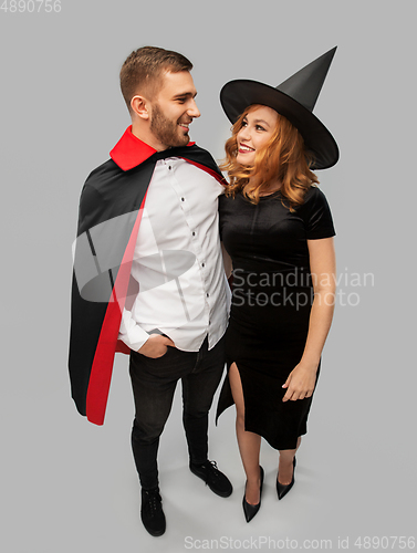 Image of couple in halloween costumes of witch and vampire