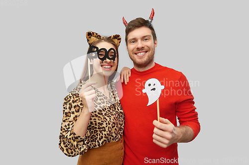 Image of couple in halloween costumes of devil and leopard