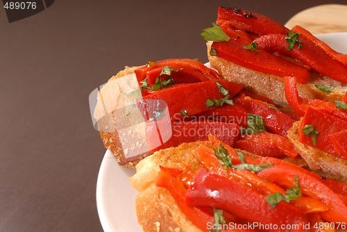 Image of Side view of roasted red pepper and basil bruschetta