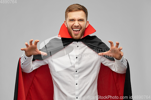 Image of man in halloween costume of vampire scaring