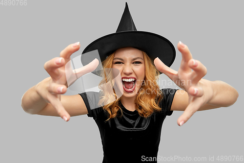 Image of scary woman in black halloween costume of witch