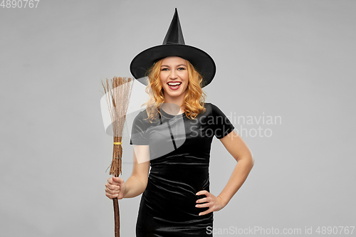 Image of woman in halloween costume of witch with broom