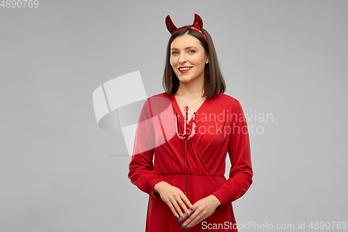 Image of happy woman in red halloween costume of devil