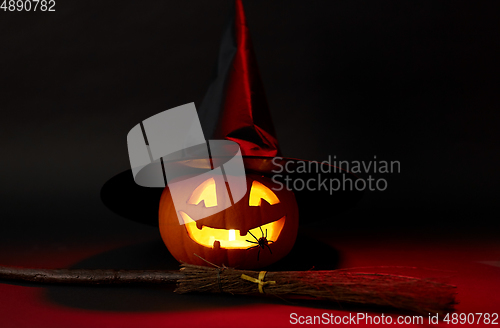 Image of halloween jack-o-lantern in witch's hat and broom