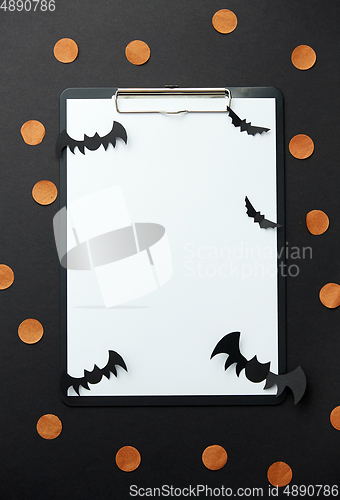 Image of clipboard and halloween party decorations