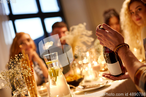 Image of happy friends with red wine at christmas party