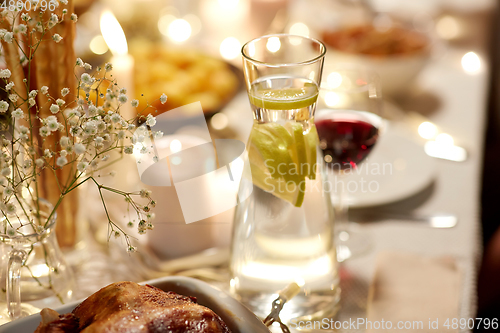Image of roast chicken on served table at home dinner party