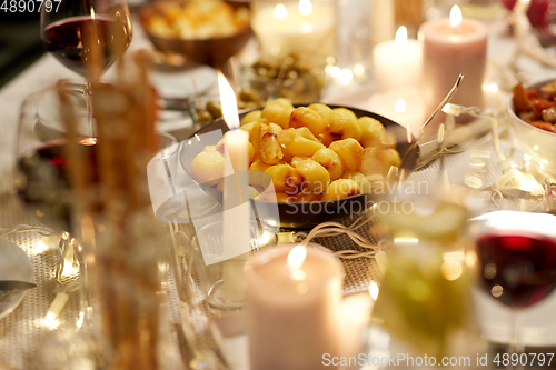 Image of baked potato on served table at home dinner party