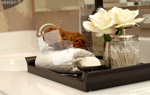 Image of Several toiletries and bath items on bathroom vanity