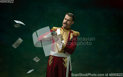 Image of Young man as Nicholas II on dark green background. Retro style, comparison of eras concept.