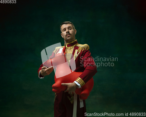 Image of Young man as Nicholas II on dark green background. Retro style, comparison of eras concept.