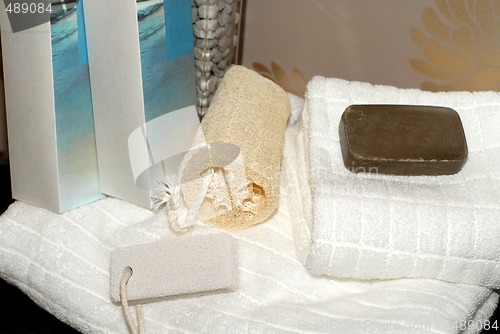 Image of Towels, soap and sponges on bathroom vanity