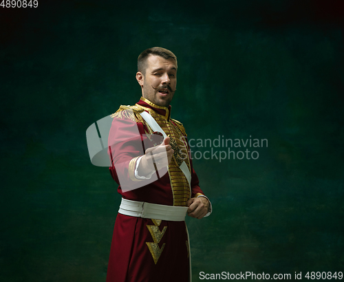 Image of Young man as Nicholas II on dark green background. Retro style, comparison of eras concept.