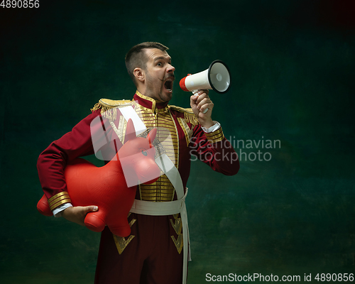 Image of Young man as Nicholas II on dark green background. Retro style, comparison of eras concept.