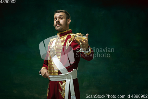 Image of Young man as Nicholas II on dark green background. Retro style, comparison of eras concept.