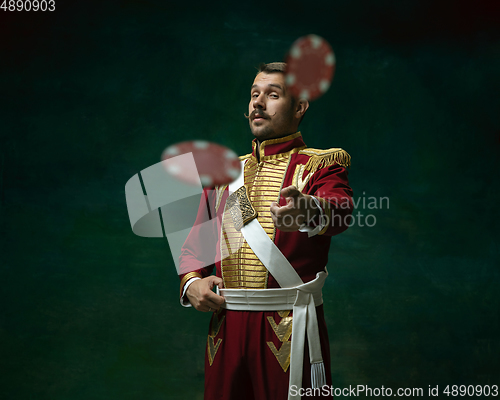 Image of Young man as Nicholas II on dark green background. Retro style, comparison of eras concept.