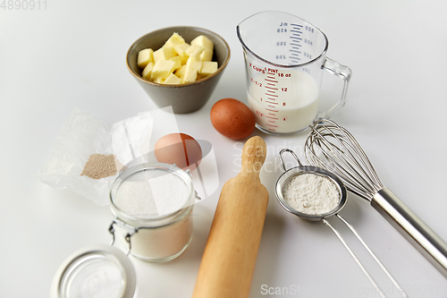 Image of rolling pin, butter, eggs, flour, milk and sugar