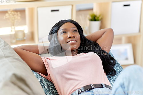 Image of happy african american young woman at home