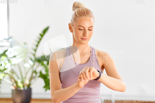 Image of woman with fitness tracker home or yoga studio