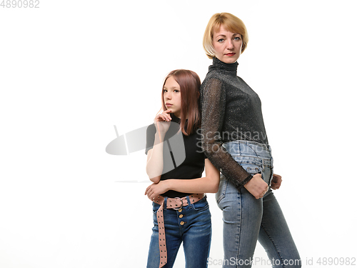 Image of Portrait of a teenager girl and a woman, the girl looks thoughtfully to the left, the woman looks into the frame