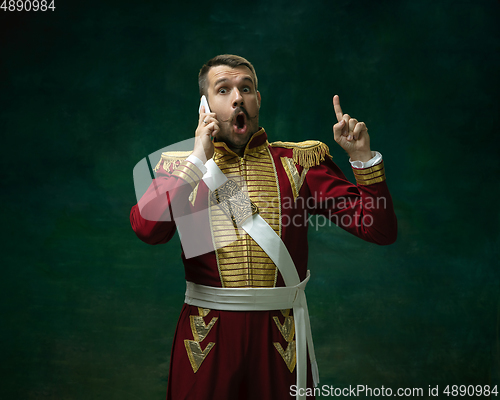 Image of Young man as Nicholas II on dark green background. Retro style, comparison of eras concept.