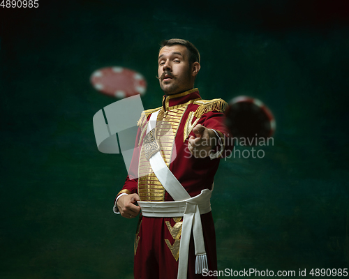 Image of Young man as Nicholas II on dark green background. Retro style, comparison of eras concept.