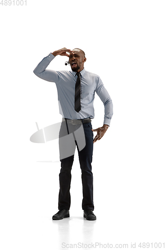 Image of Young african-american call center consultant with headset isolated on white studio background