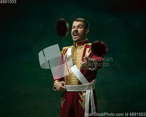 Image of Young man as Nicholas II on dark green background. Retro style, comparison of eras concept.