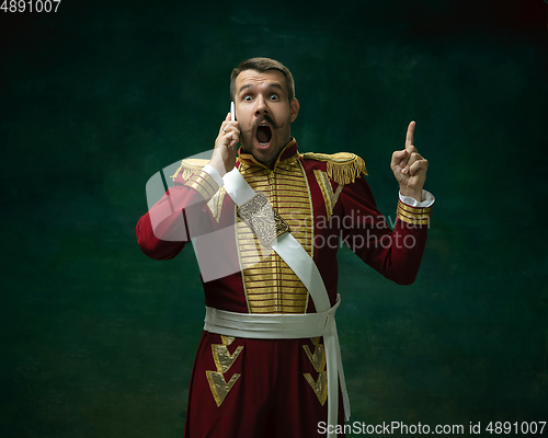 Image of Young man as Nicholas II on dark green background. Retro style, comparison of eras concept.