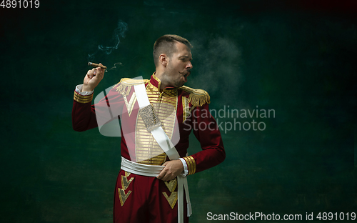 Image of Young man as Nicholas II on dark green background. Retro style, comparison of eras concept.