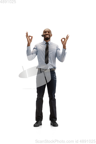 Image of Young african-american call center consultant with headset isolated on white studio background