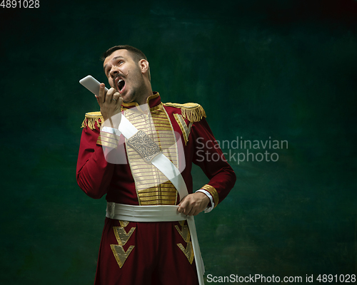 Image of Young man as Nicholas II on dark green background. Retro style, comparison of eras concept.